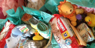 A basket of baby diapers, toys and things
